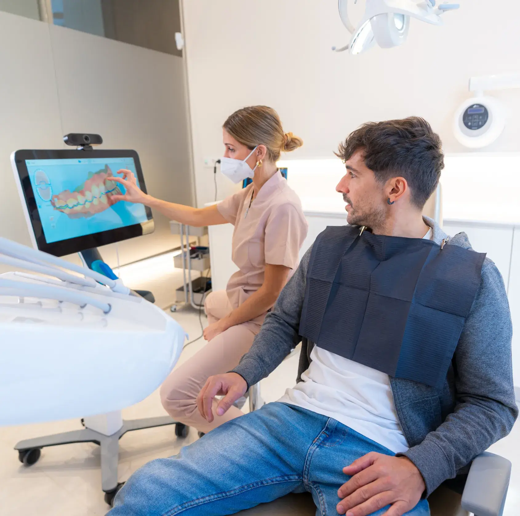 A man and a woman in a dental room.