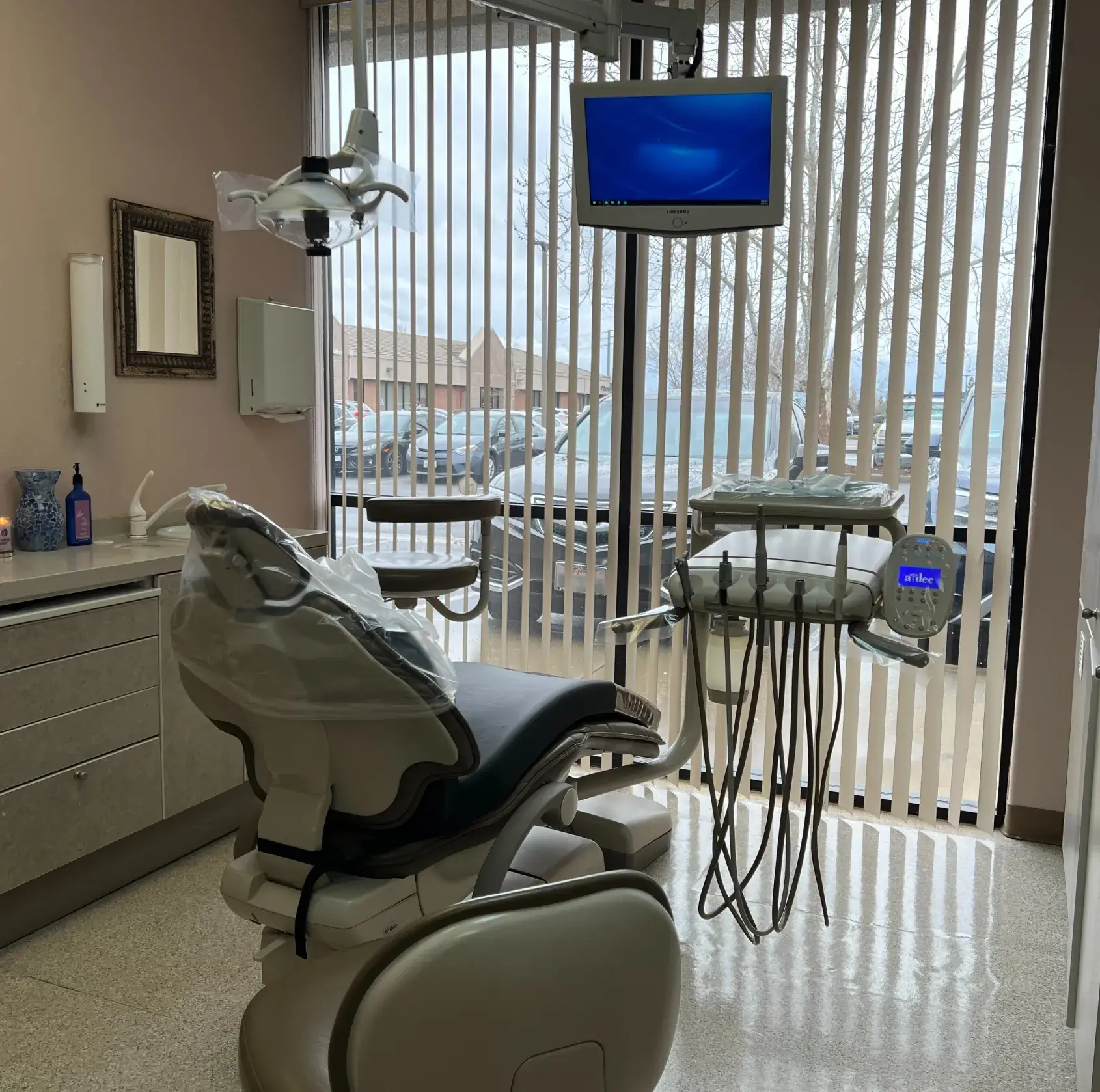 A dentist chair in a room with a television.