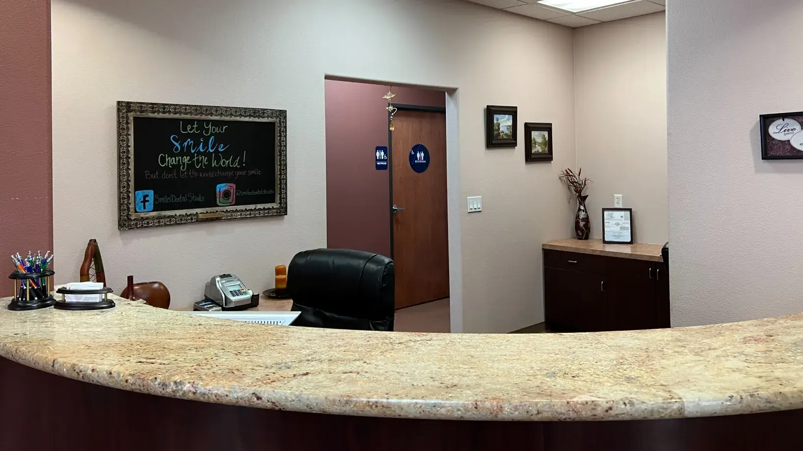 A reception area with a chalkboard on the wall.