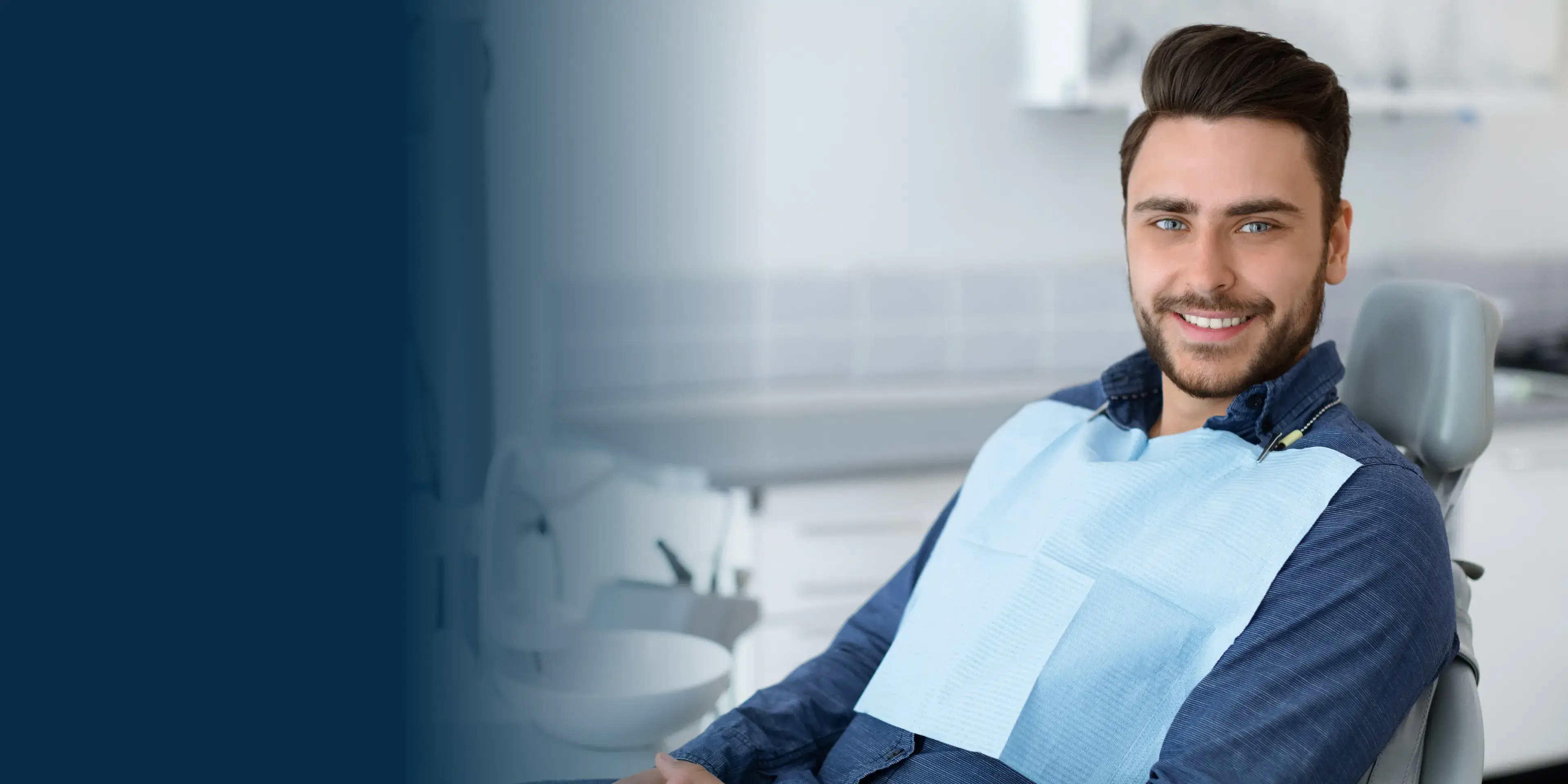 Smiling man sitting on dentist chair