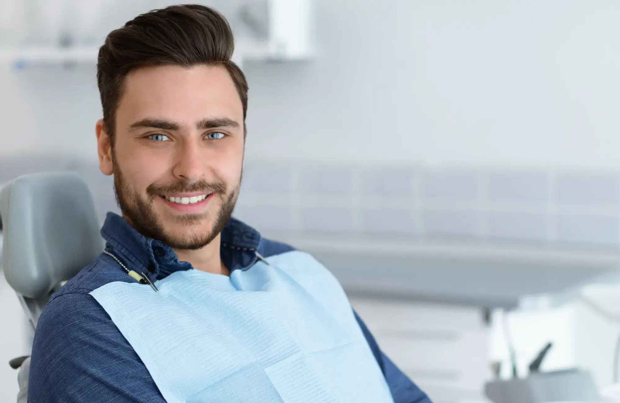Smiling man sitting on dentist chair