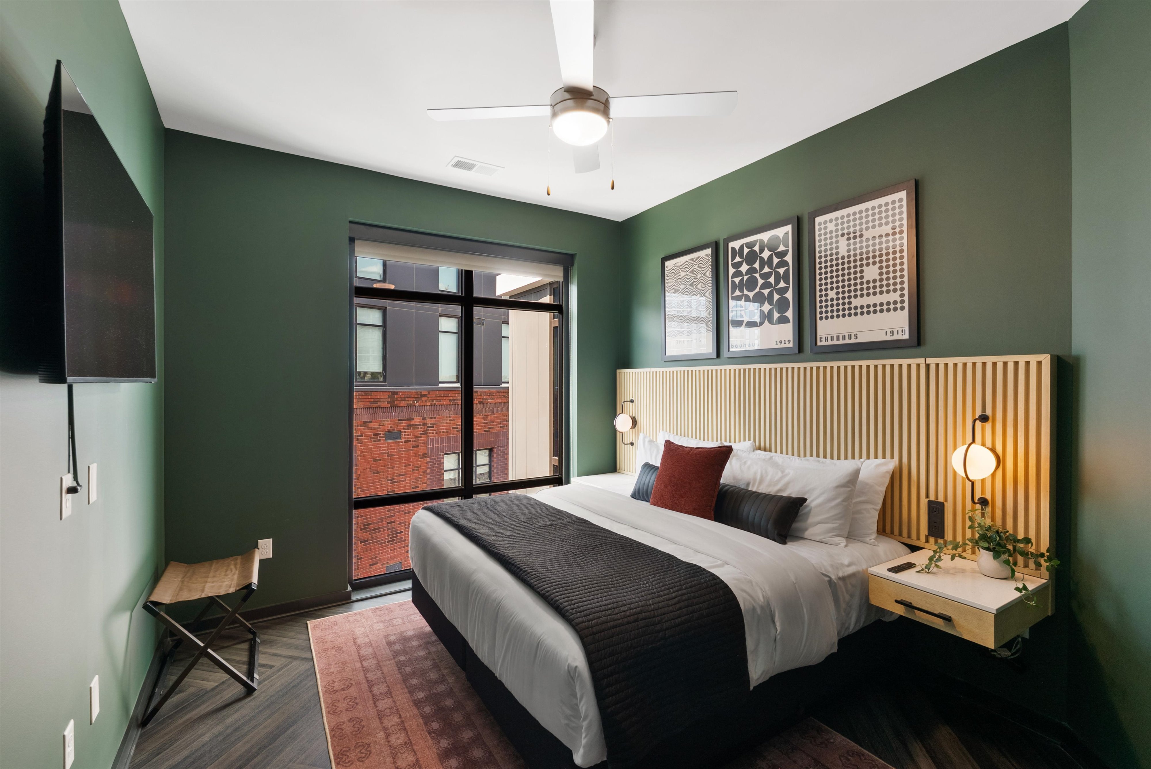 King bedroom with floor to ceiling windows at The Quinley boutique hotel in The Gulch, Nashville