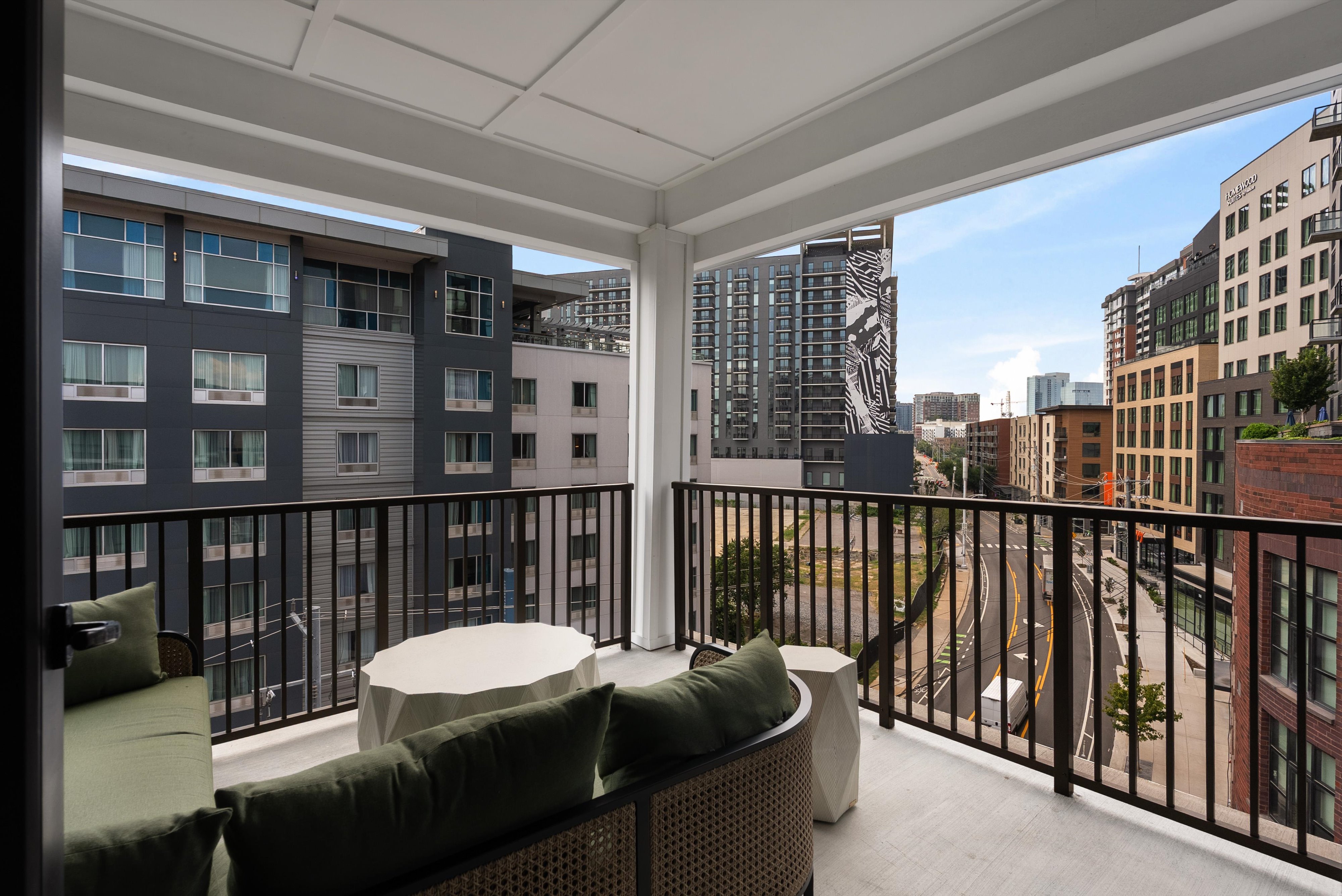 Open door to the balcony in a boutique hotel room suite at The Quinley in The Gulch, Nashville