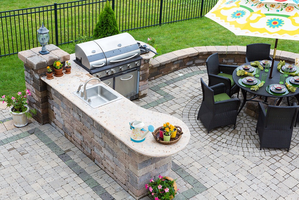 Backyard kitchen and grille installed by Opulands hardscape contractors.