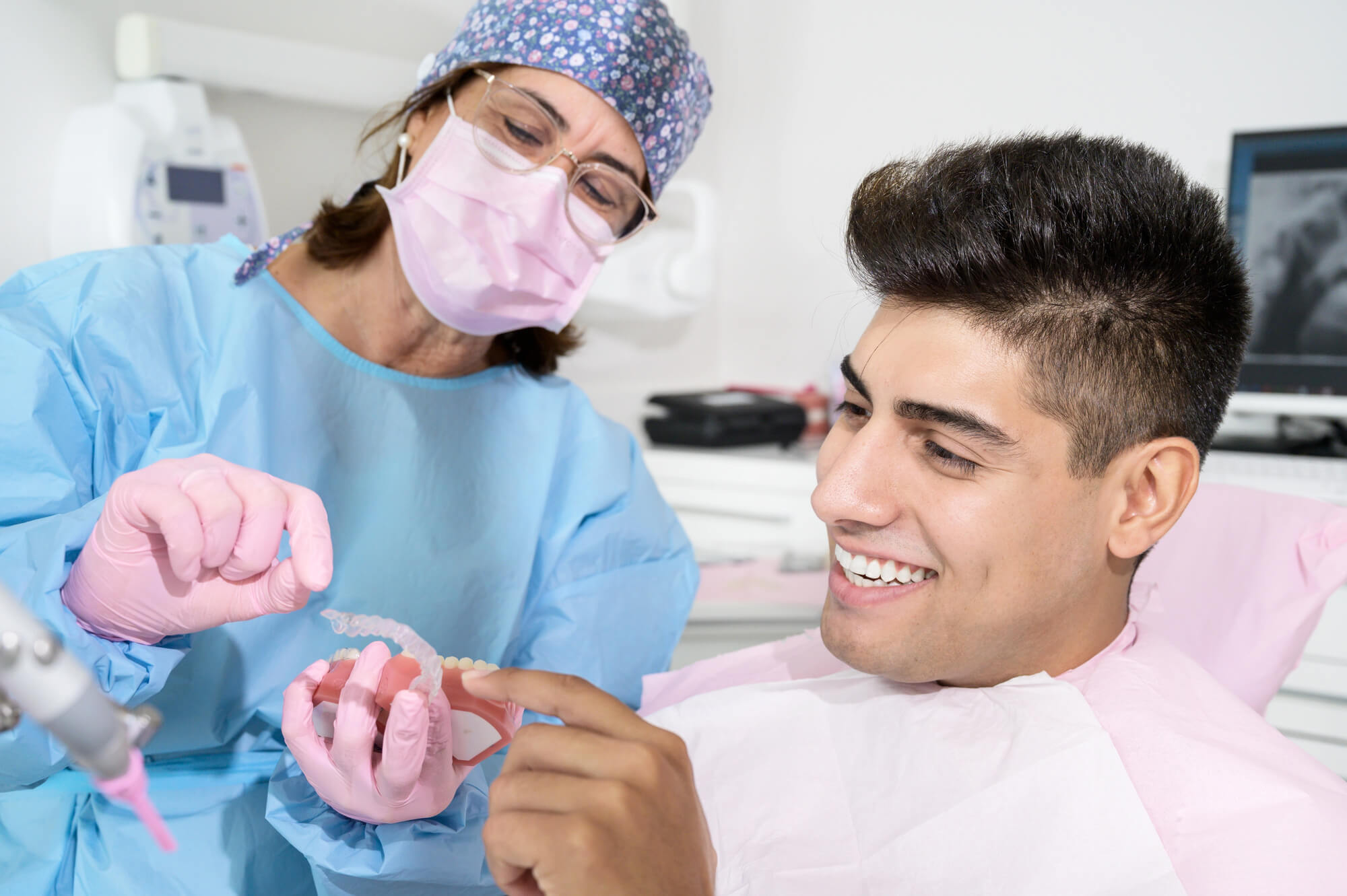dentist showing clear aligner to a patient