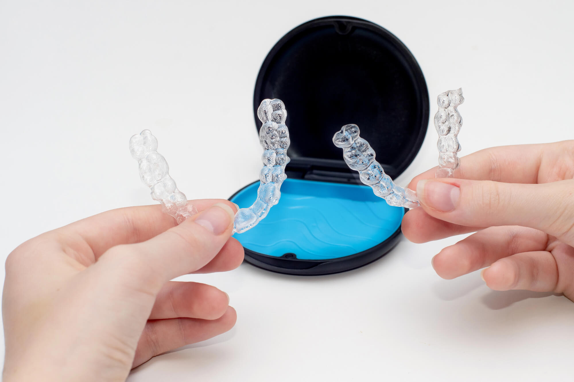 people holding clear aligners