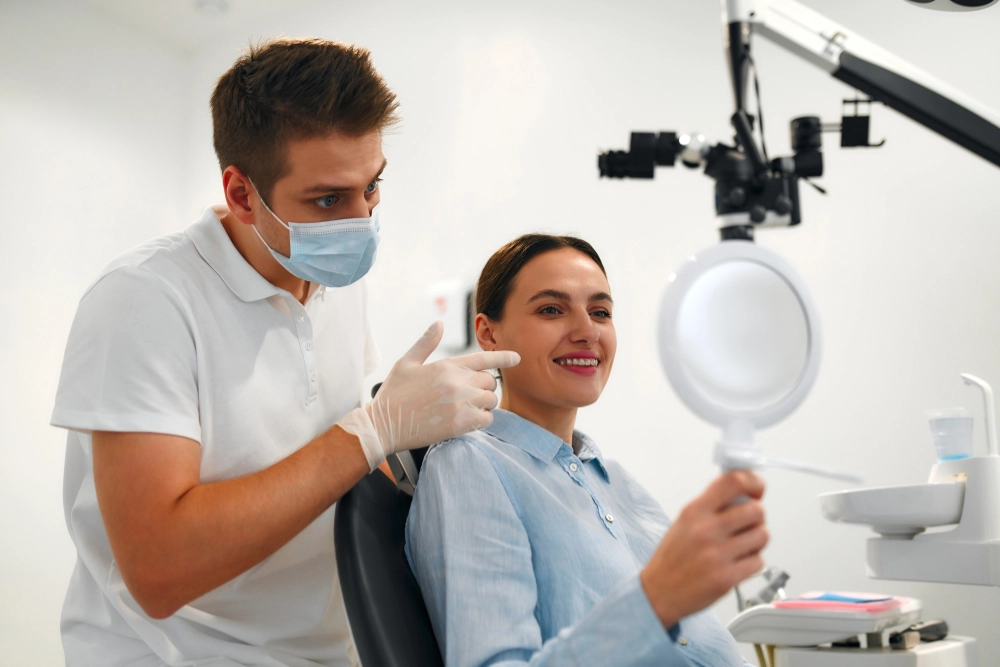 dental patient looking at her smile in the mirror