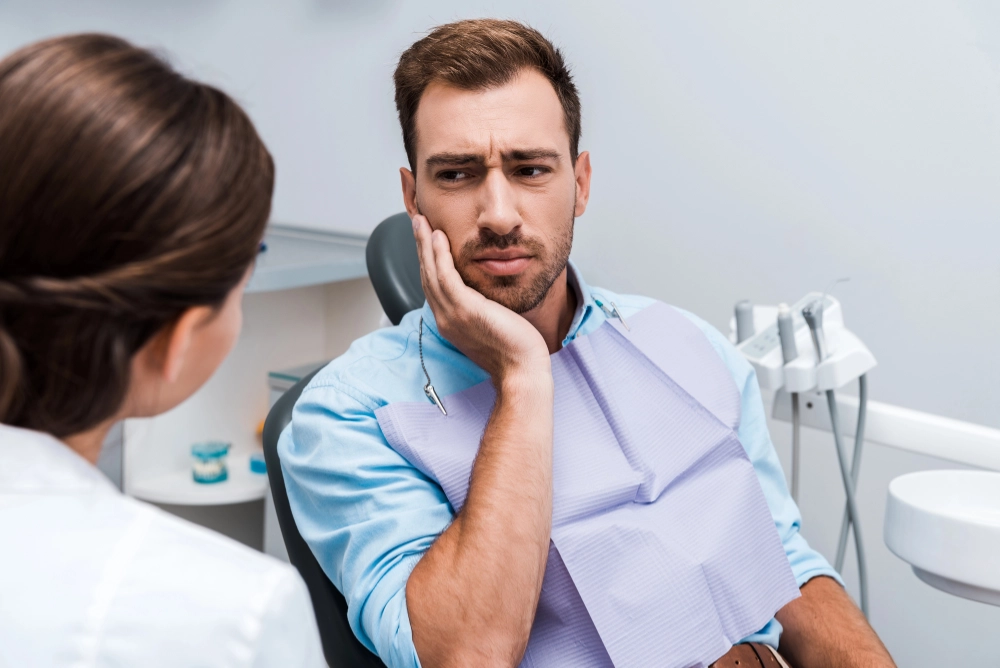 man with dental pain at the dentist