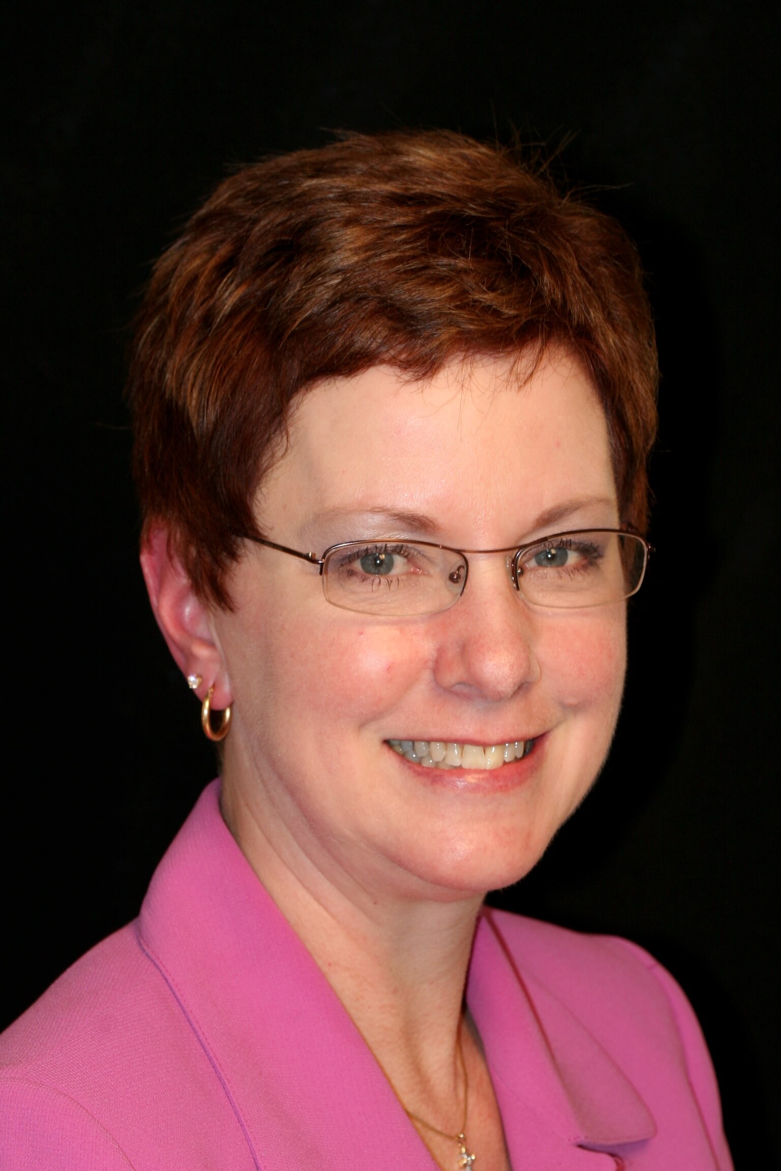 woman with glasses smiling