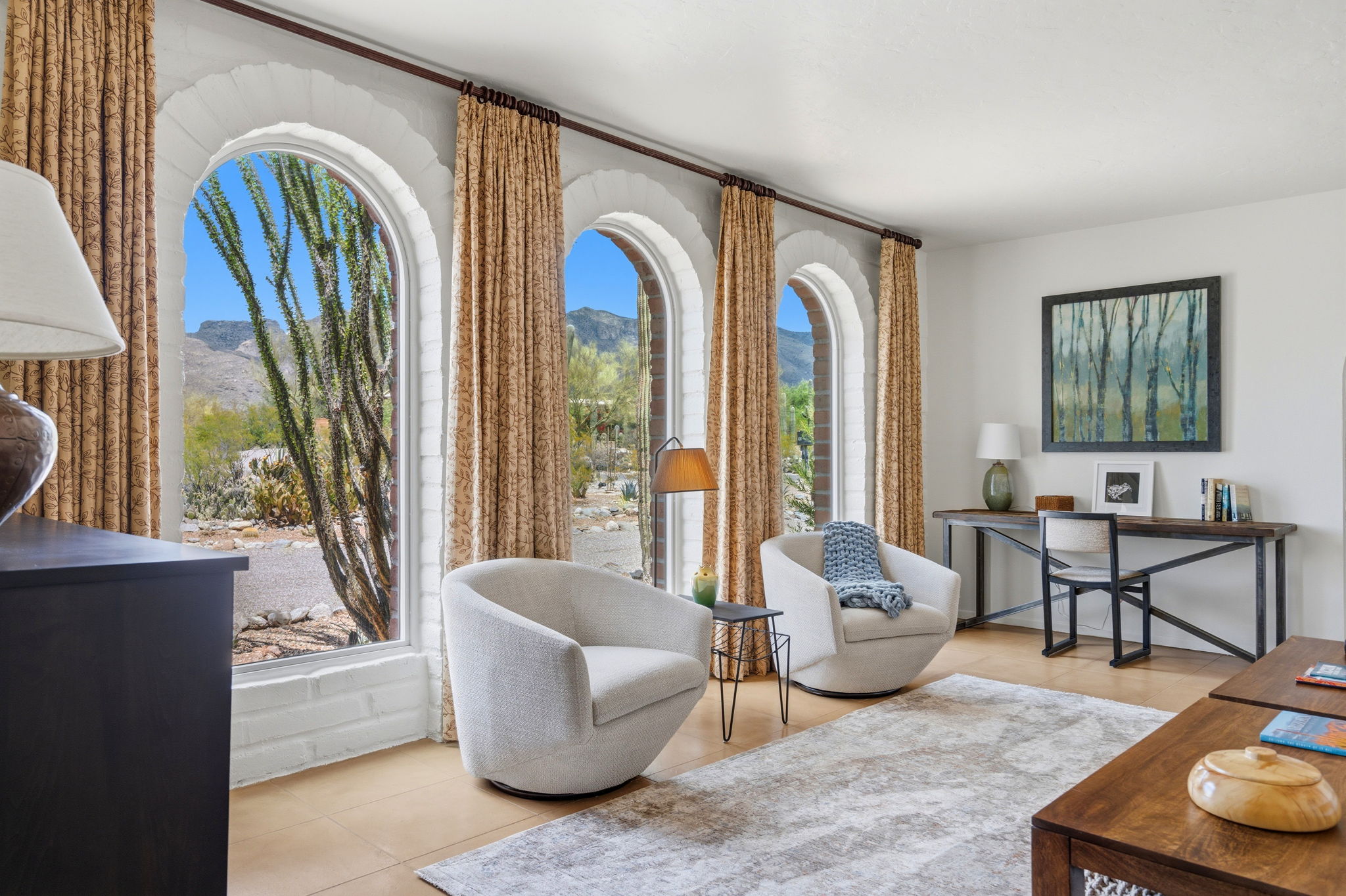 Bright rental living room with seating and arched windows