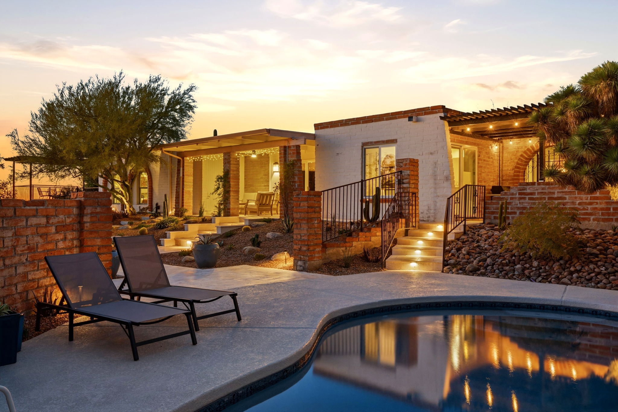 Vacation rental home, pool, and backyard at dusk