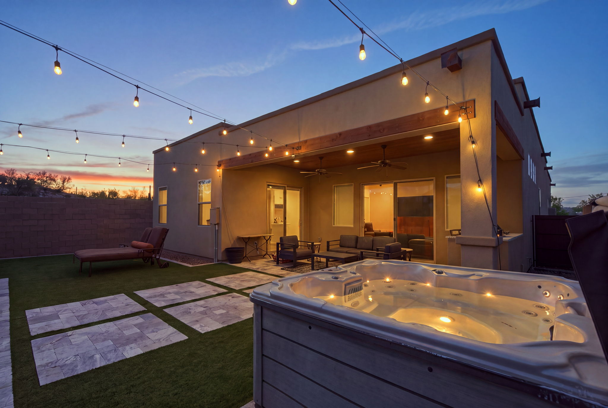 Outdoor hot tub and string lights at twilight