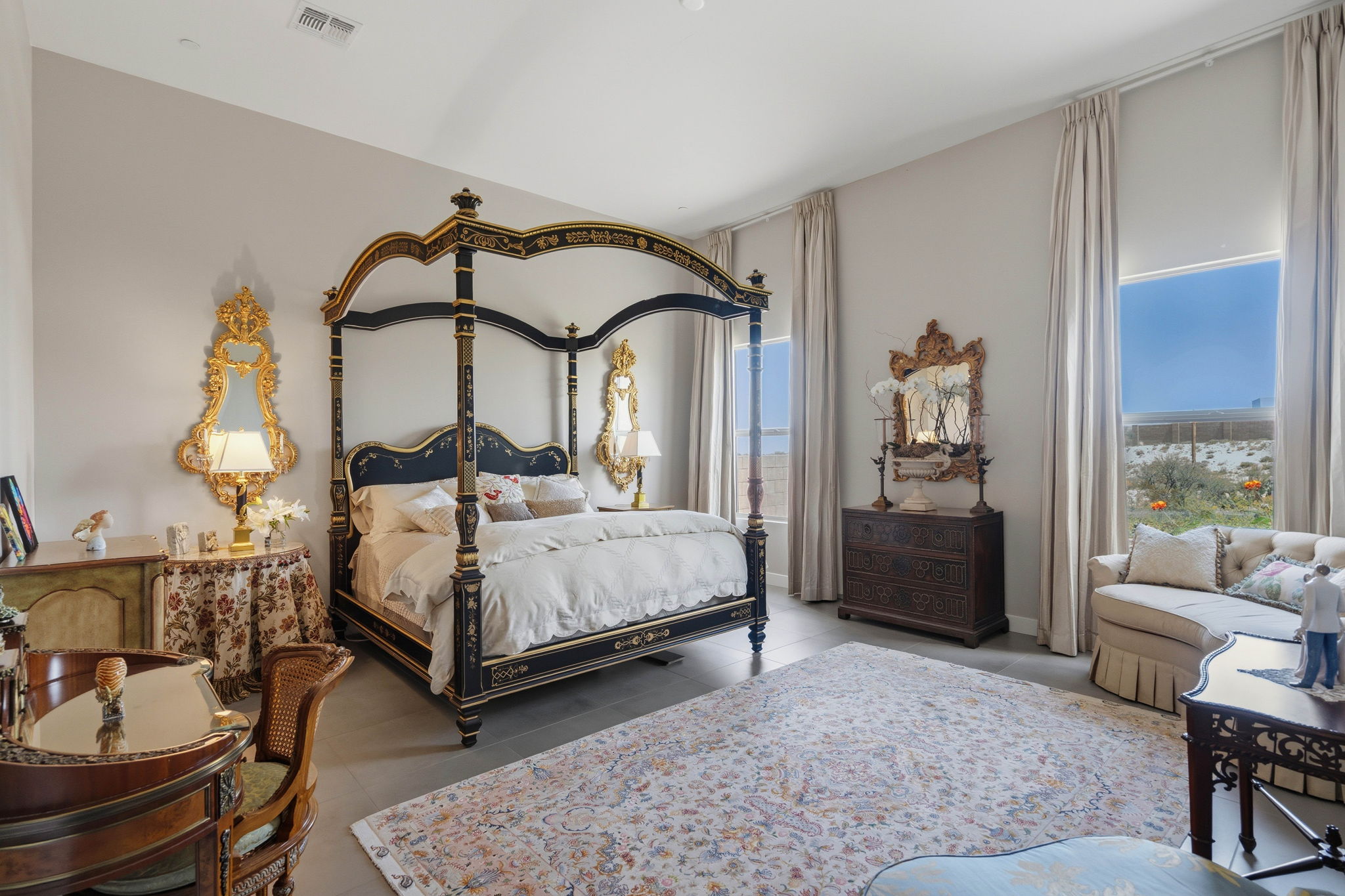 Elegant bedroom with black and gold canopy bed