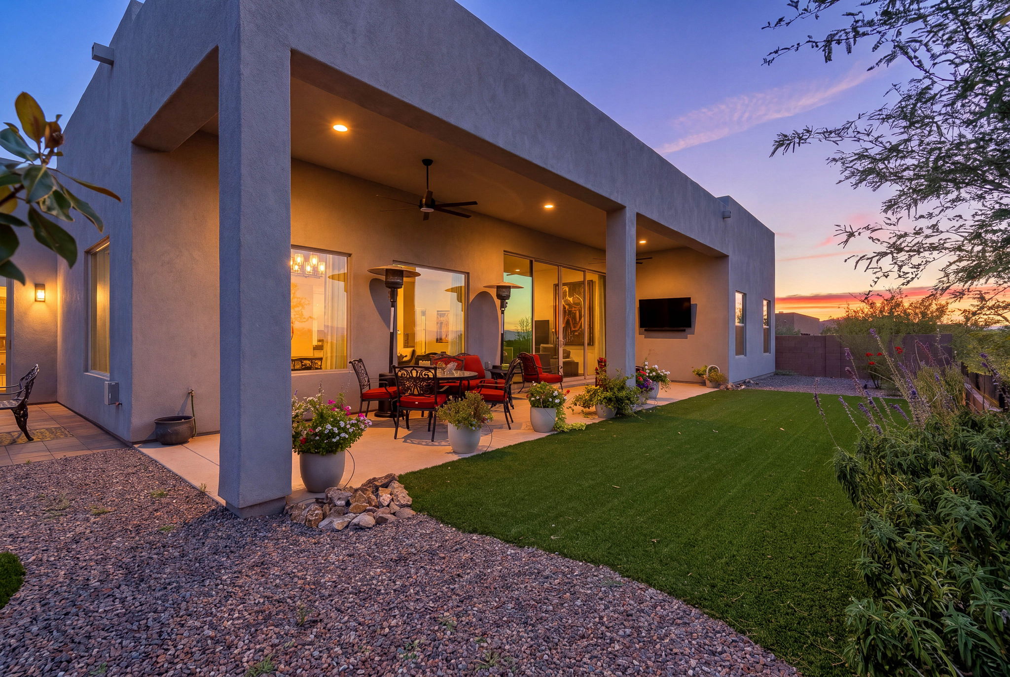 Backyard and outdoor living area photographed at dusk.
