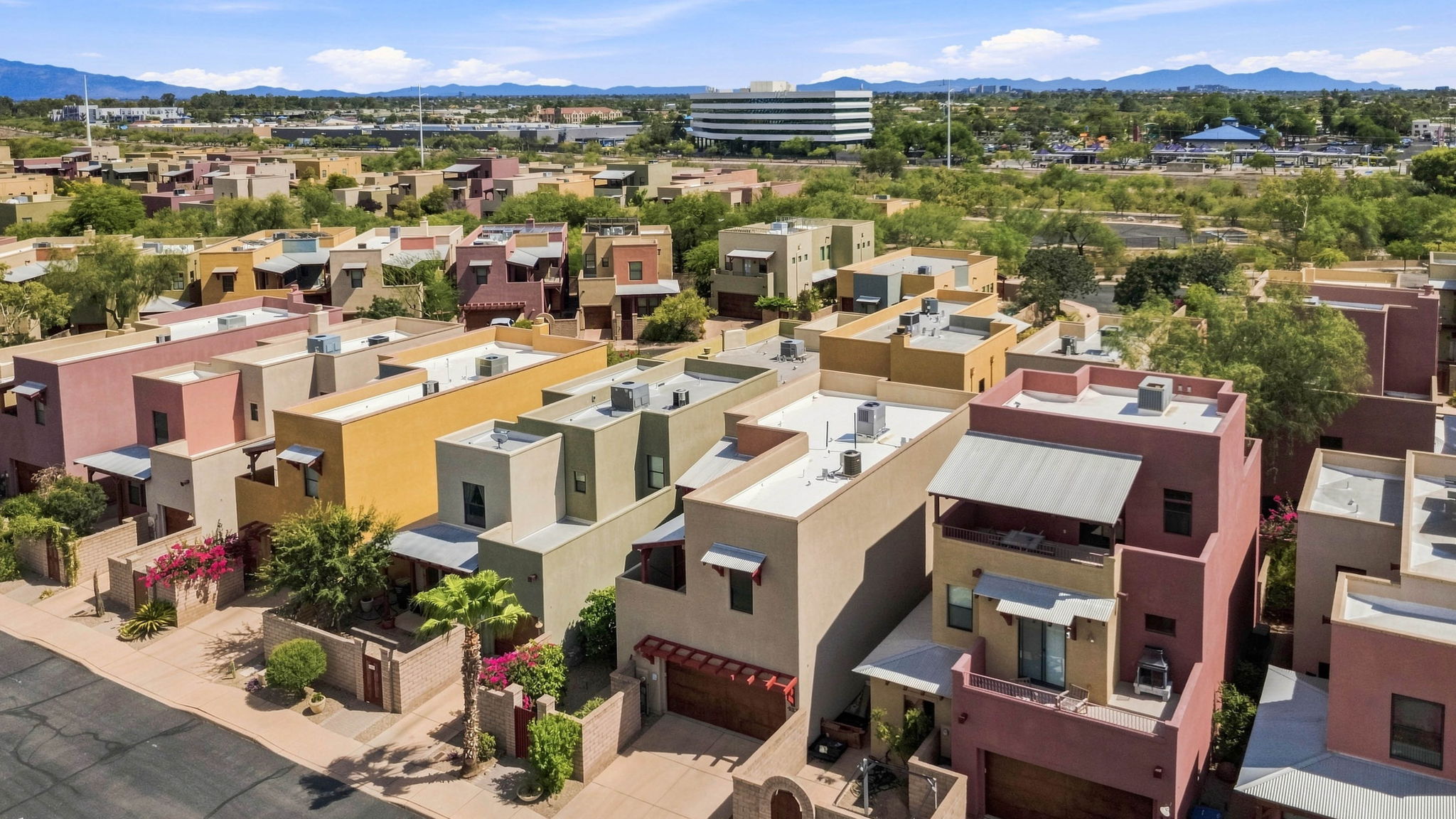 Aerial view of colorful three-story condos and the surrounding neighborhood