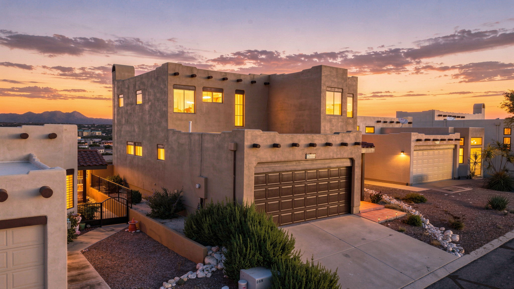 Elevated view of a two-story desert home at dusk