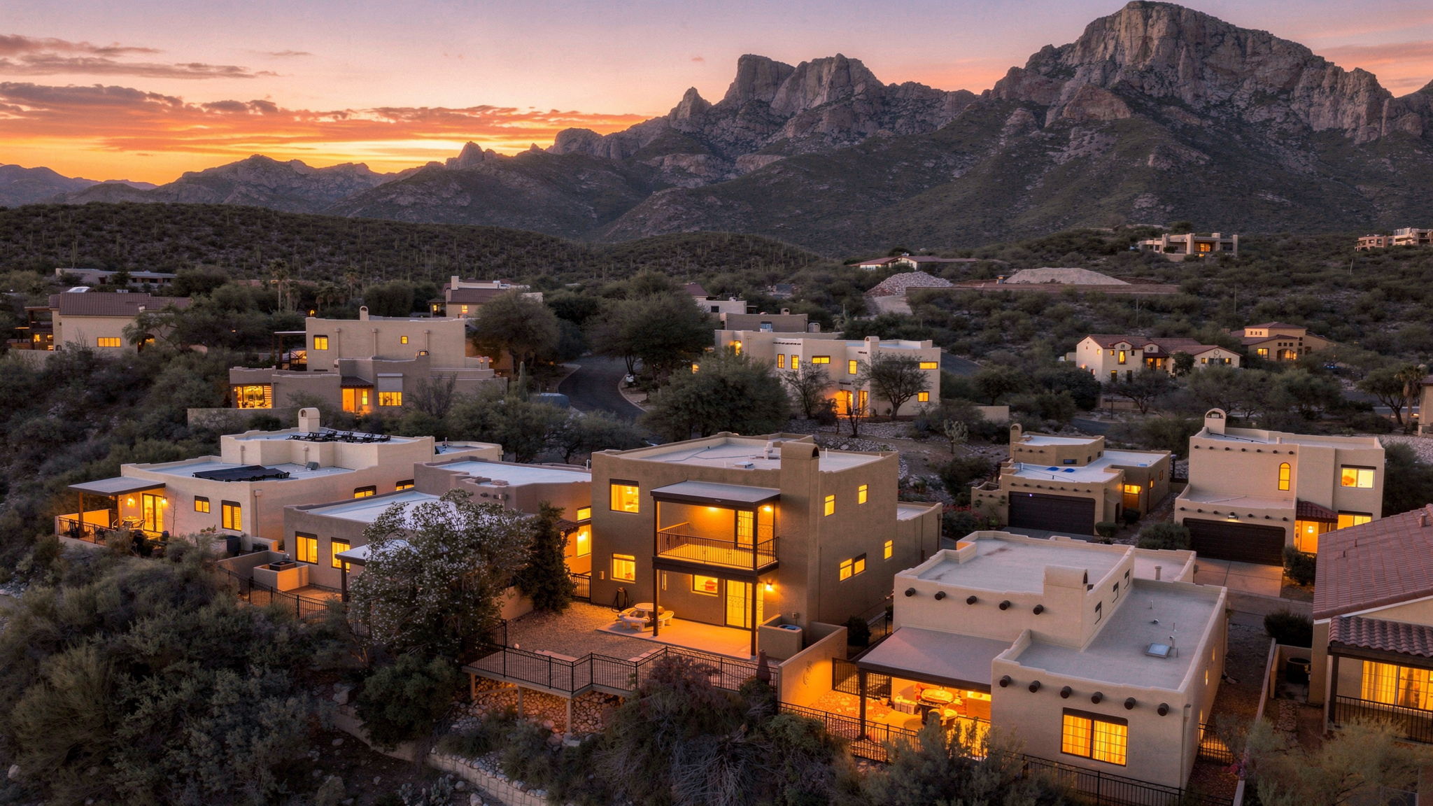 La Reserve homes below rugged mountains at sunset