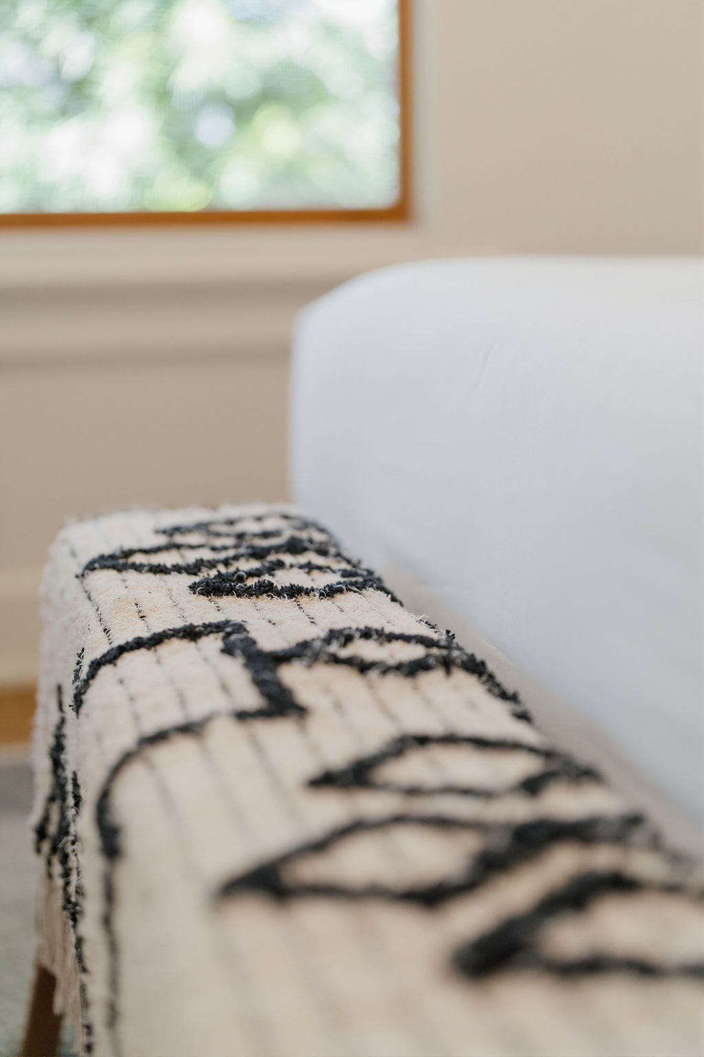 Southwestern patterned throw draped over a cream sofa