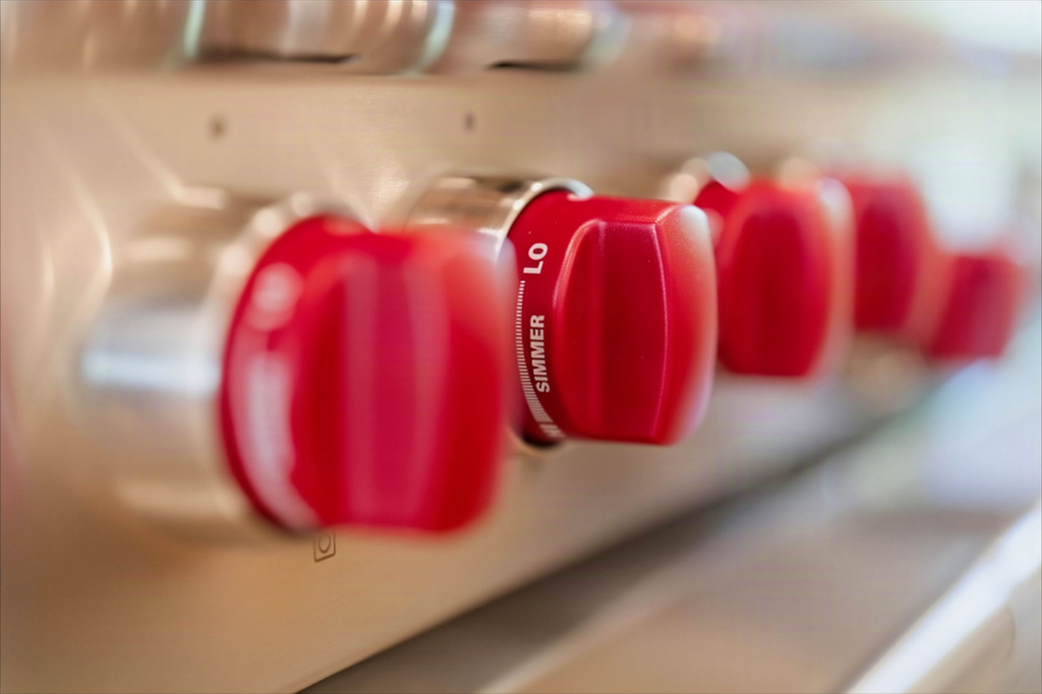 Red control knobs on a stainless steel range