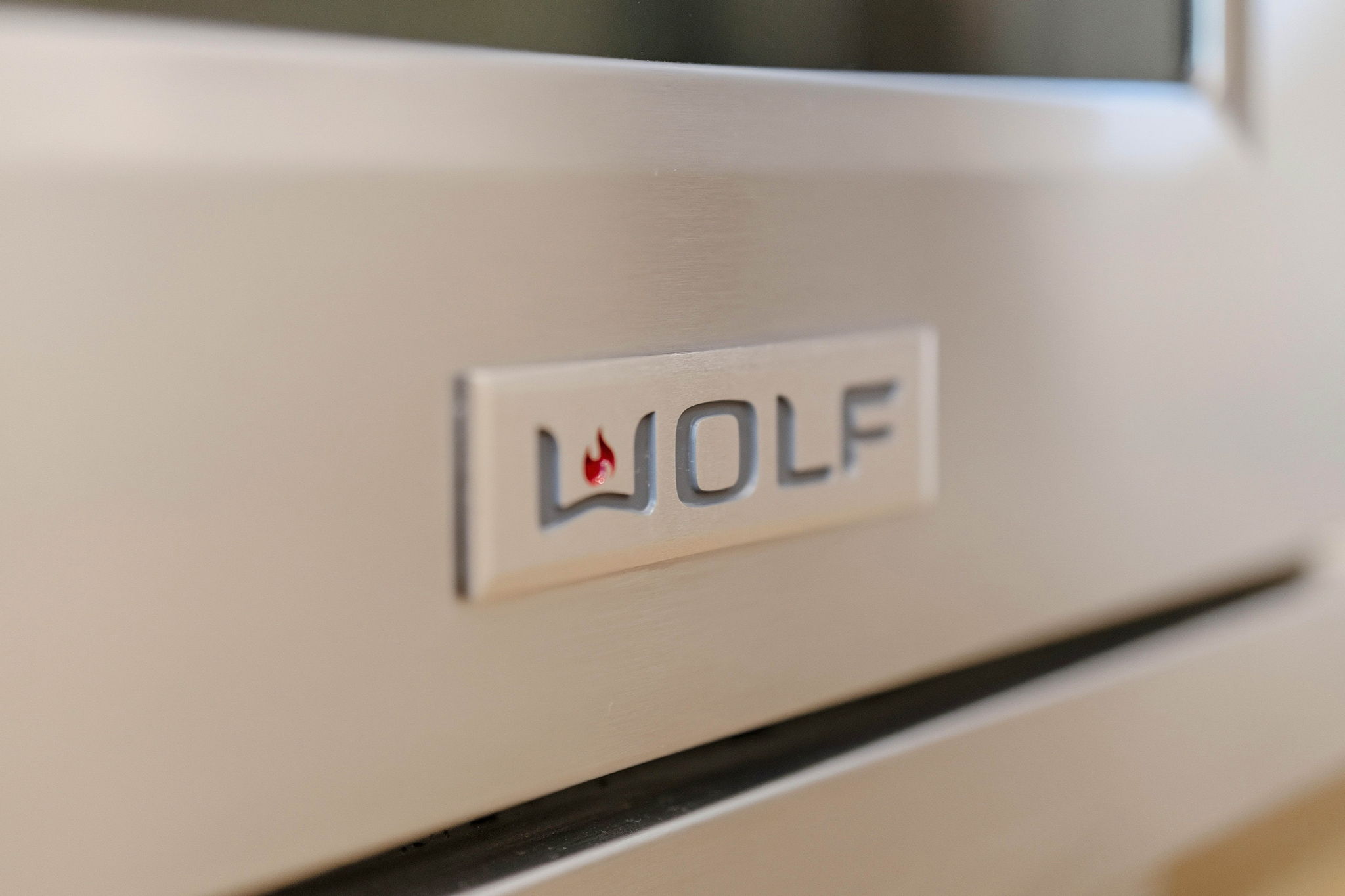Wolf emblem on a brushed stainless steel oven