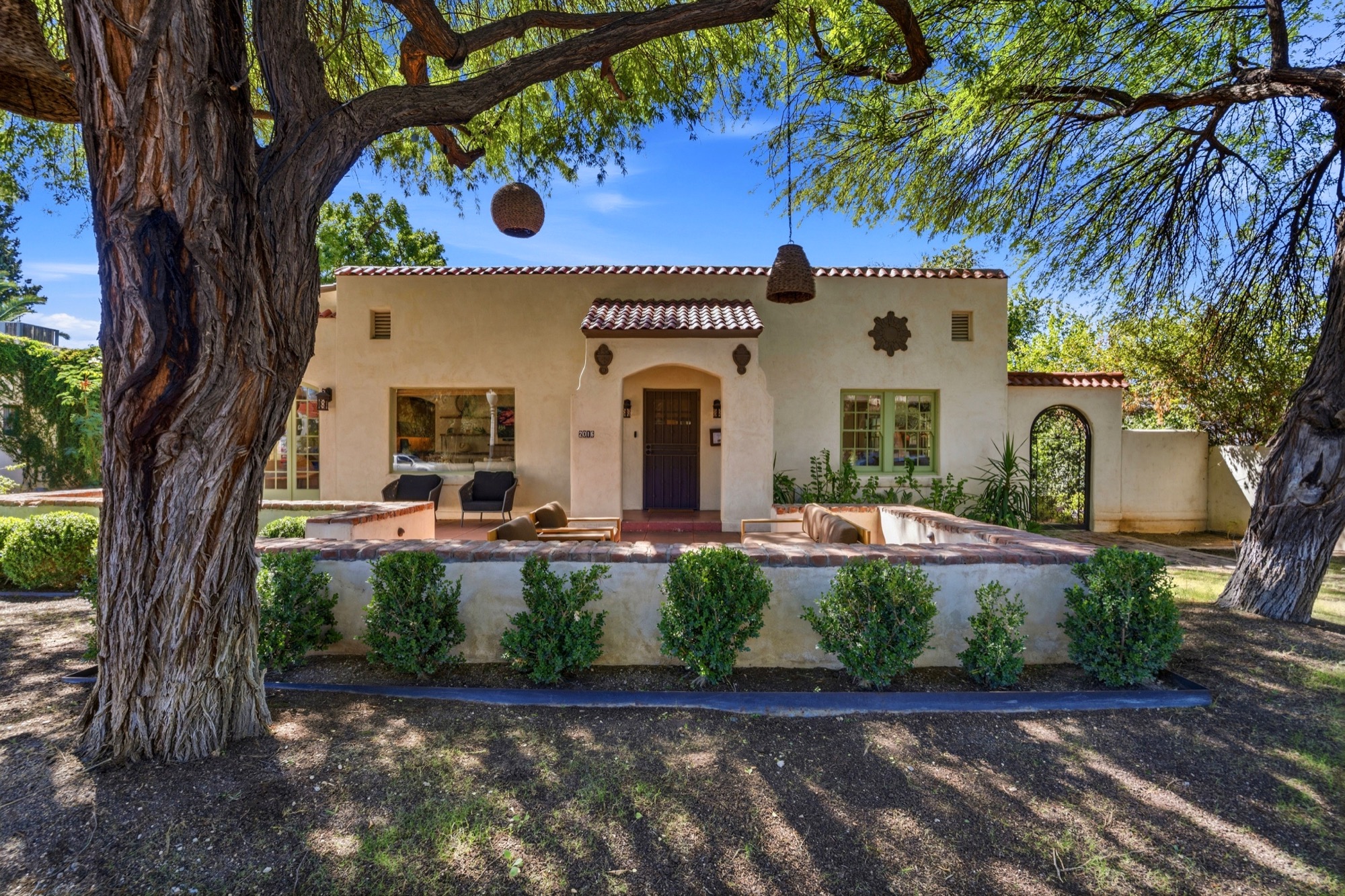 Daylight exterior of a Tucson home framed by mature trees