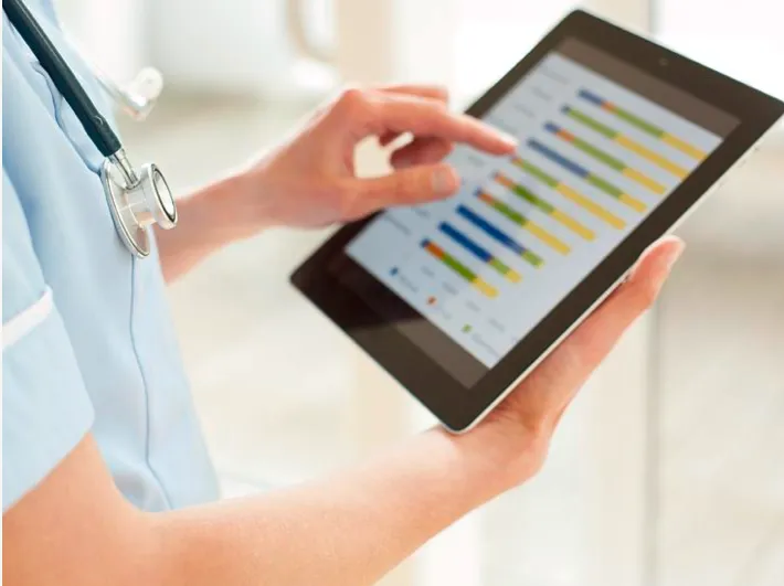 Hand holding a tablet running the Medi-Sci clinical app