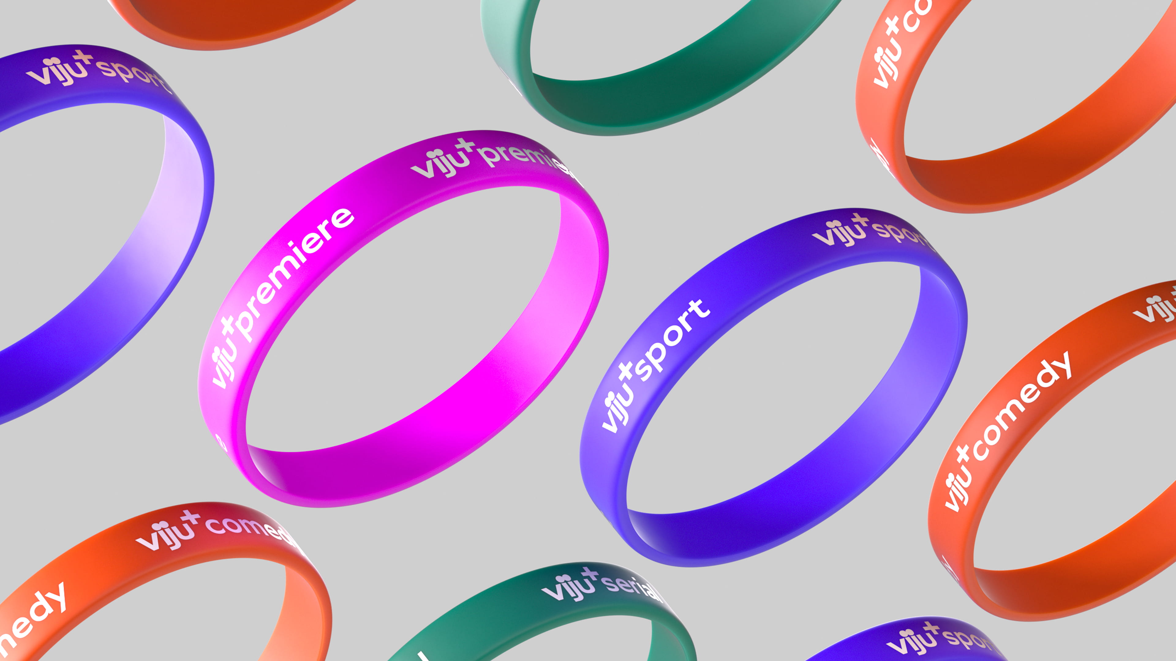 Colorful silicone wristbands floating on a light gray background with labels including 'viju+ premiere,' 'viju+ sport,' 'viju+ comedy,' and 'viju+ serial'.