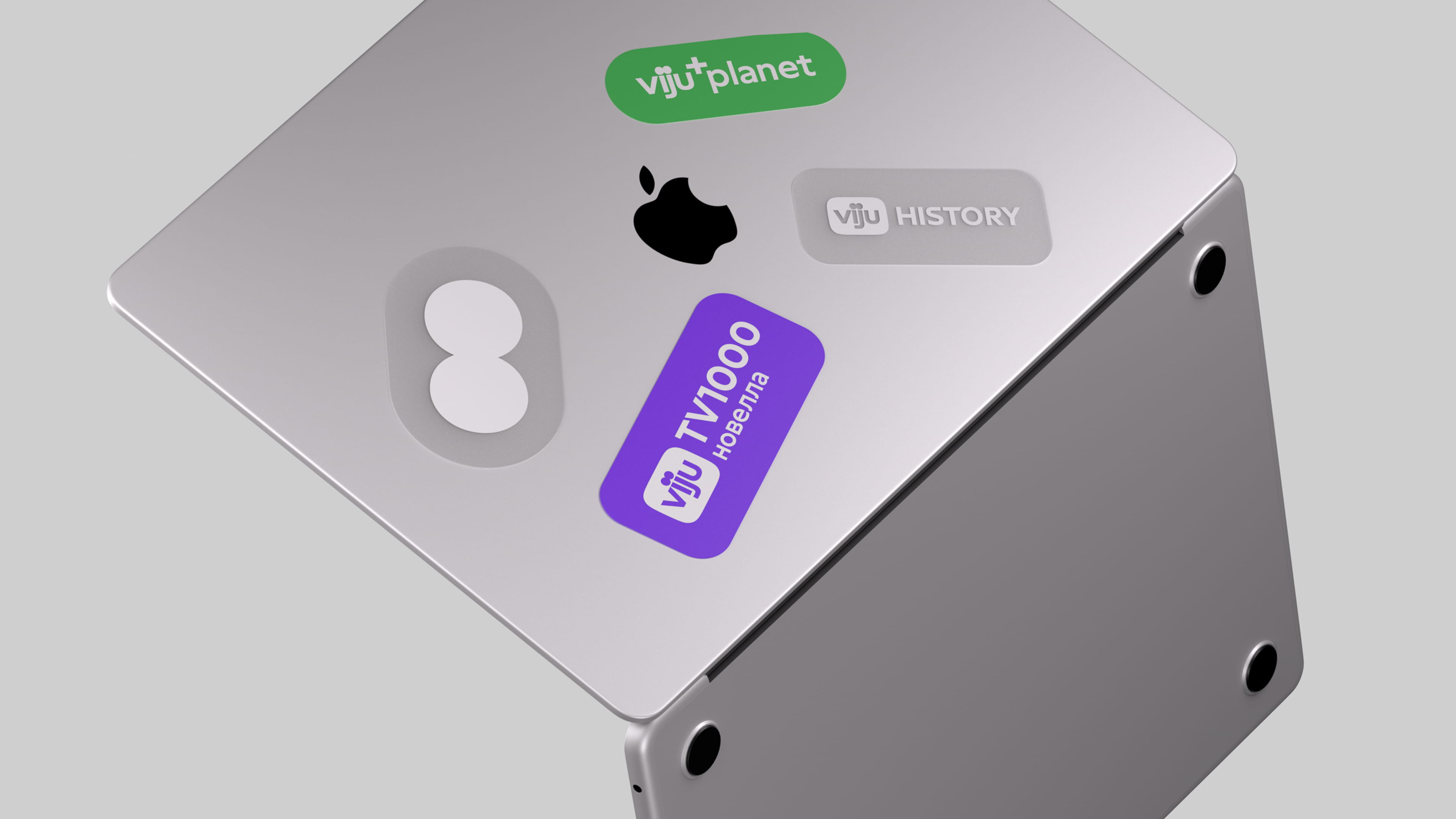 Silver Apple Mac Studio computer with stickers including 'viju+planet', Apple logo, 'viju HISTORY', and 'viju TV1000 новелла'.
