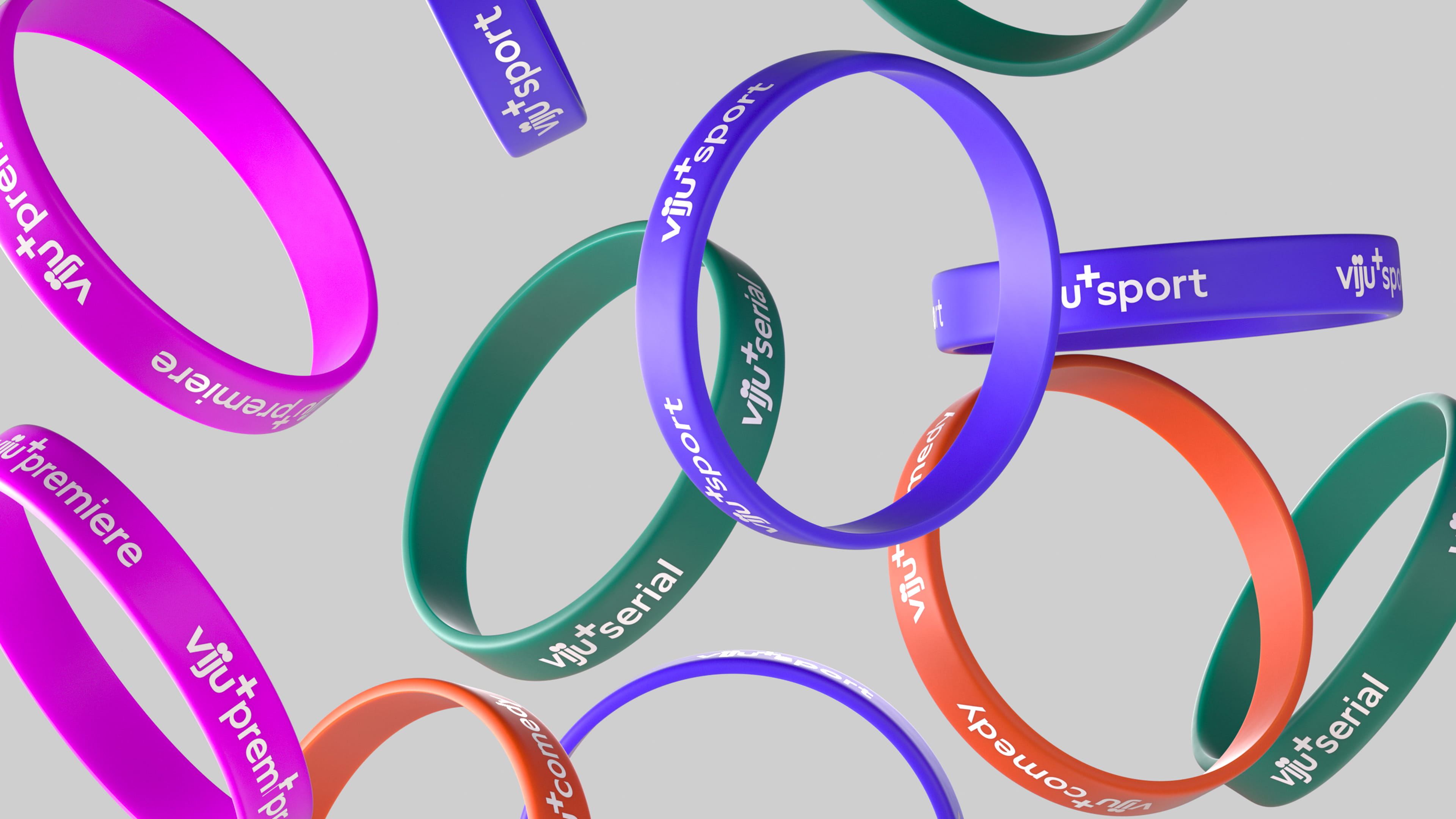 Floating colorful silicone wristbands with white text showing categories like viju+premiere, viju+sport, viju+serial, and viju+comedy on a gray background.