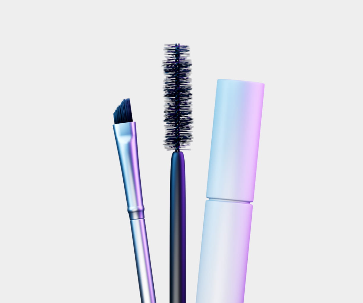 Metallic makeup brush with angled bristles, mascara wand with black bristles, and an iridescent pastel purple and blue mascara tube on a light background.