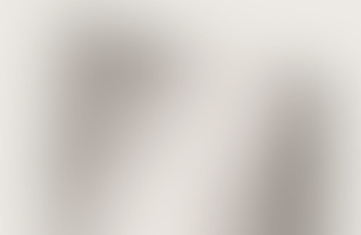 Abstract soft grey and beige blurred background with diagonal shadows.