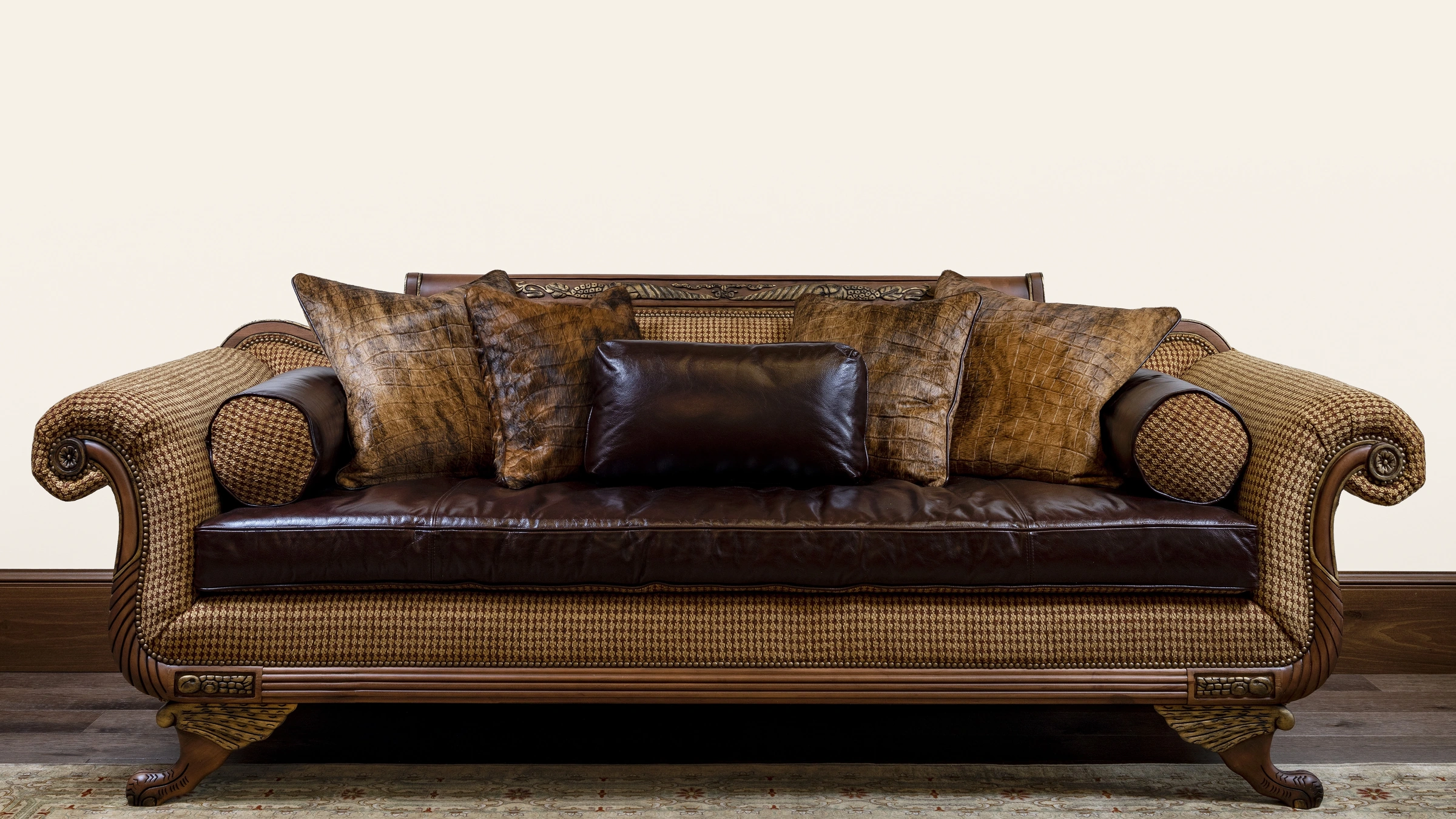 The Duncan Phyfe sofa against a softly shaded ivory wall, with its original carved wood, leather, upholstery, hardwood floor and rug