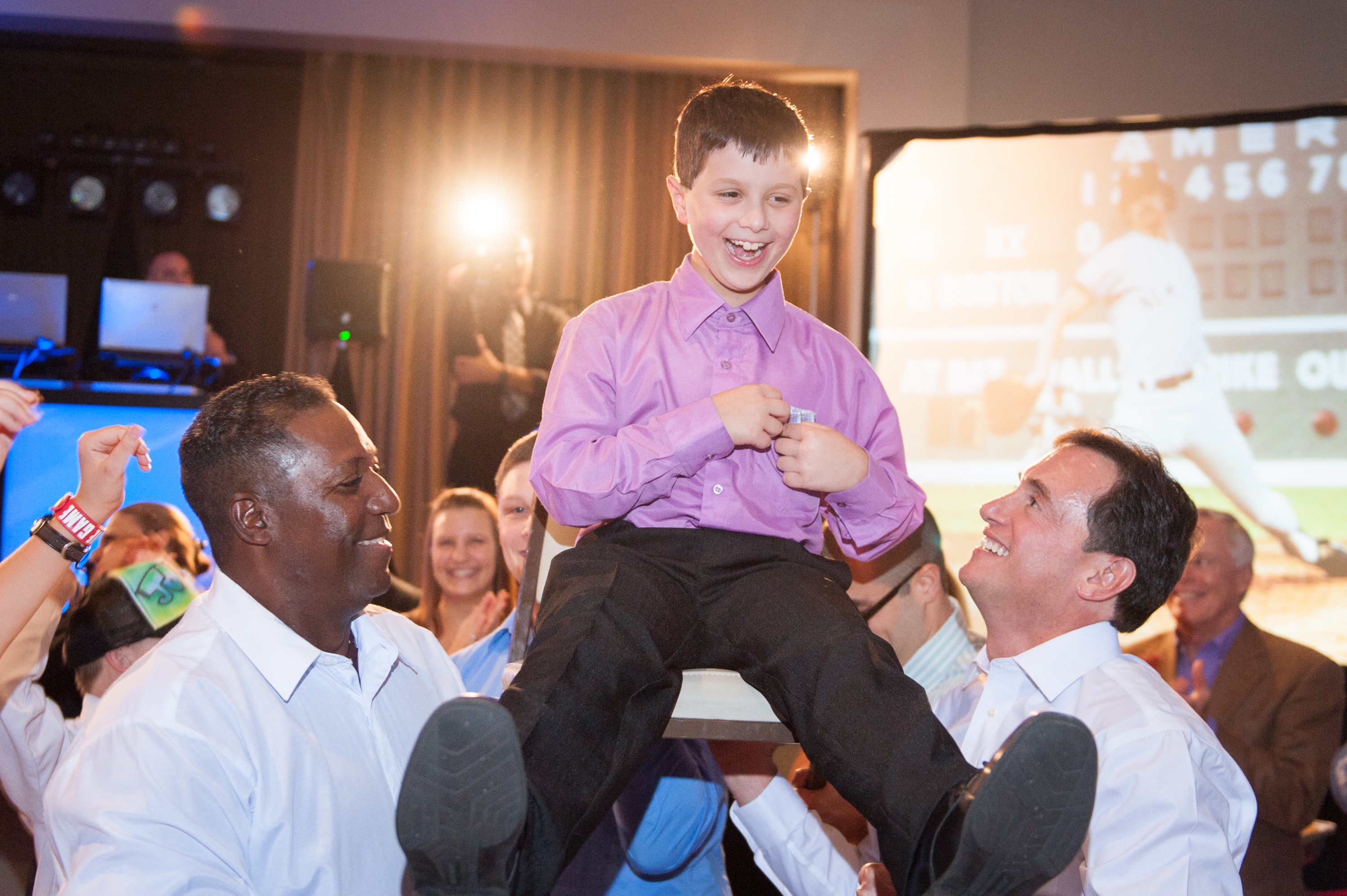 Photo of a mitzvah boy celebrating his Bar Mitzvah while doing the hora.
