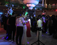 Photo taken at a high school prom hosted at Kapok Tree while couples are slow dancing to a song.