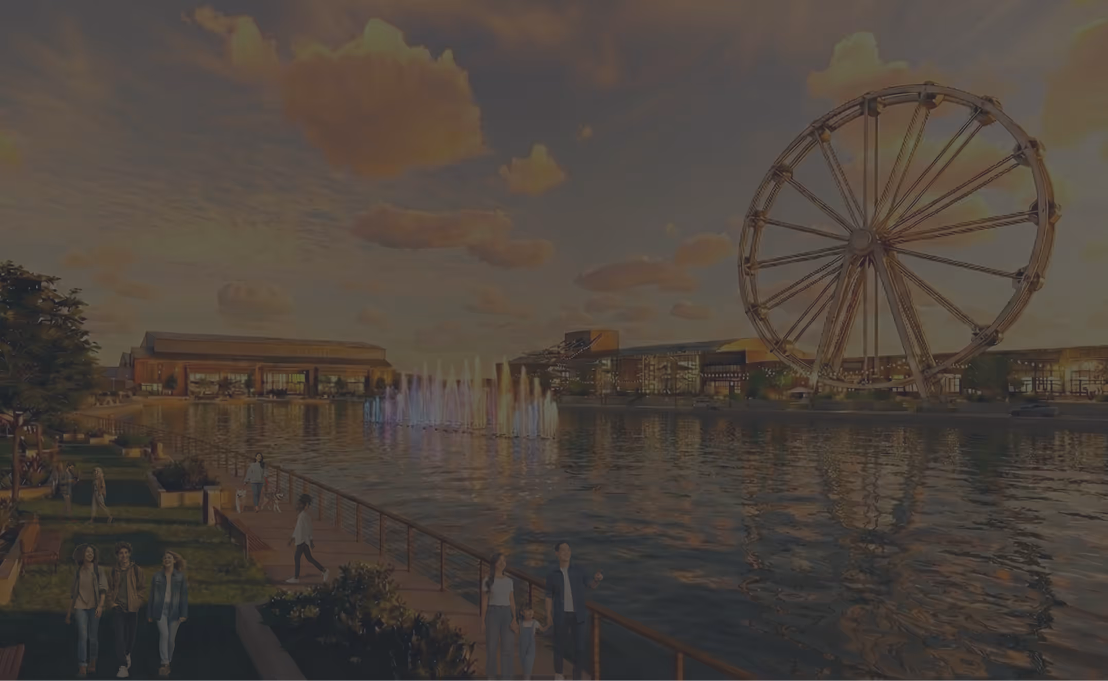 Waterfront promenade at sunset with colorful water fountains, people walking, modern buildings, and a large Ferris wheel reflecting on the water.