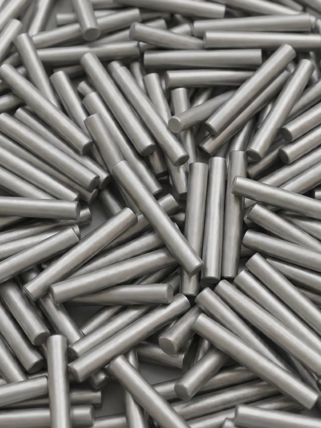 A smooth, cylindrical metal rod with a dull silver finish isolated on a white background. Shot blasting pre treatment.
