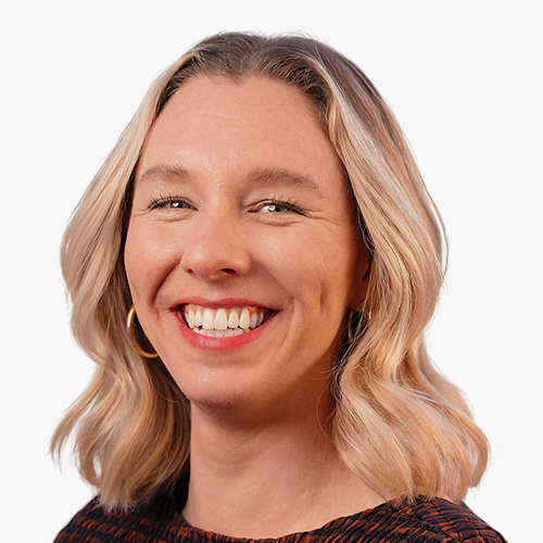 Headshot of Kaela Crampton smiling against a plain background.