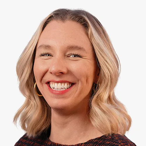 Headshot of Kaela Crampton smiling against a plain background.