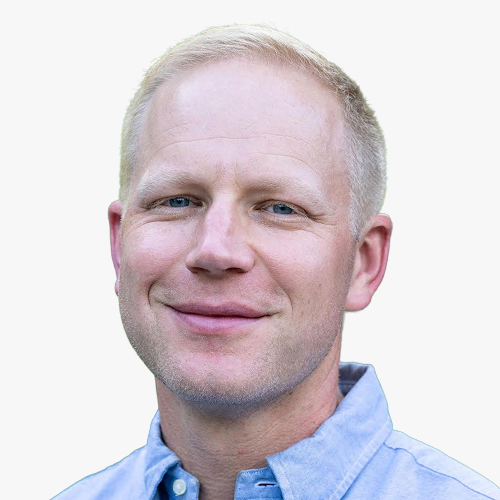 Headshot of Will Dayton smiling against a plain background.