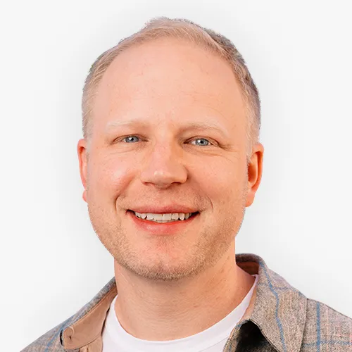 Headshot of Will Dayton smiling against a plain background.