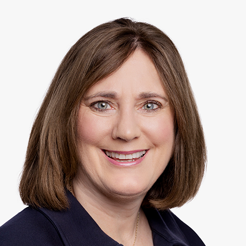 Headshot of Sabrina Stover smiling against a plain background.