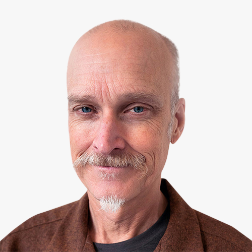 Headshot of Mike Smith smiling against a plain background.