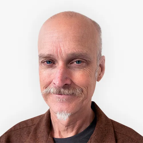 Headshot of Mike Smith smiling against a plain background.