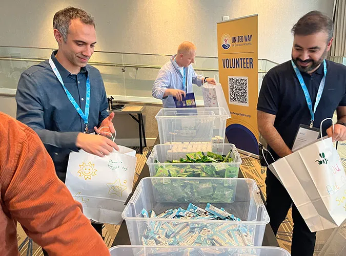 Swiftly employees packing donation bags at a United Way community volunteer event.