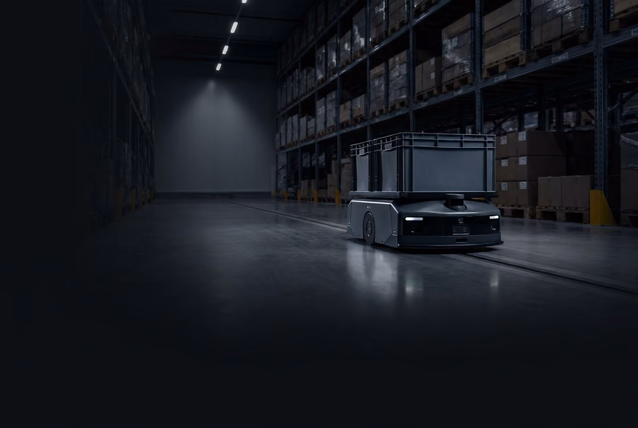 Autonomous mobile robot transporting goods through a warehouse aisle.