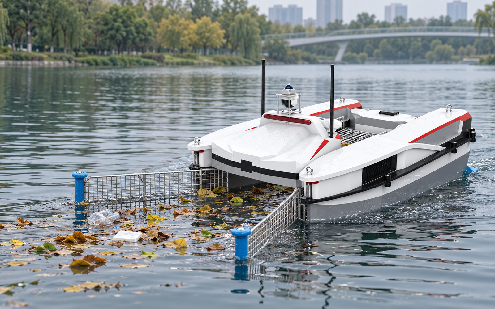A twin-hull surface cleaning vessel collecting leaves and light floating litter on a park lake.