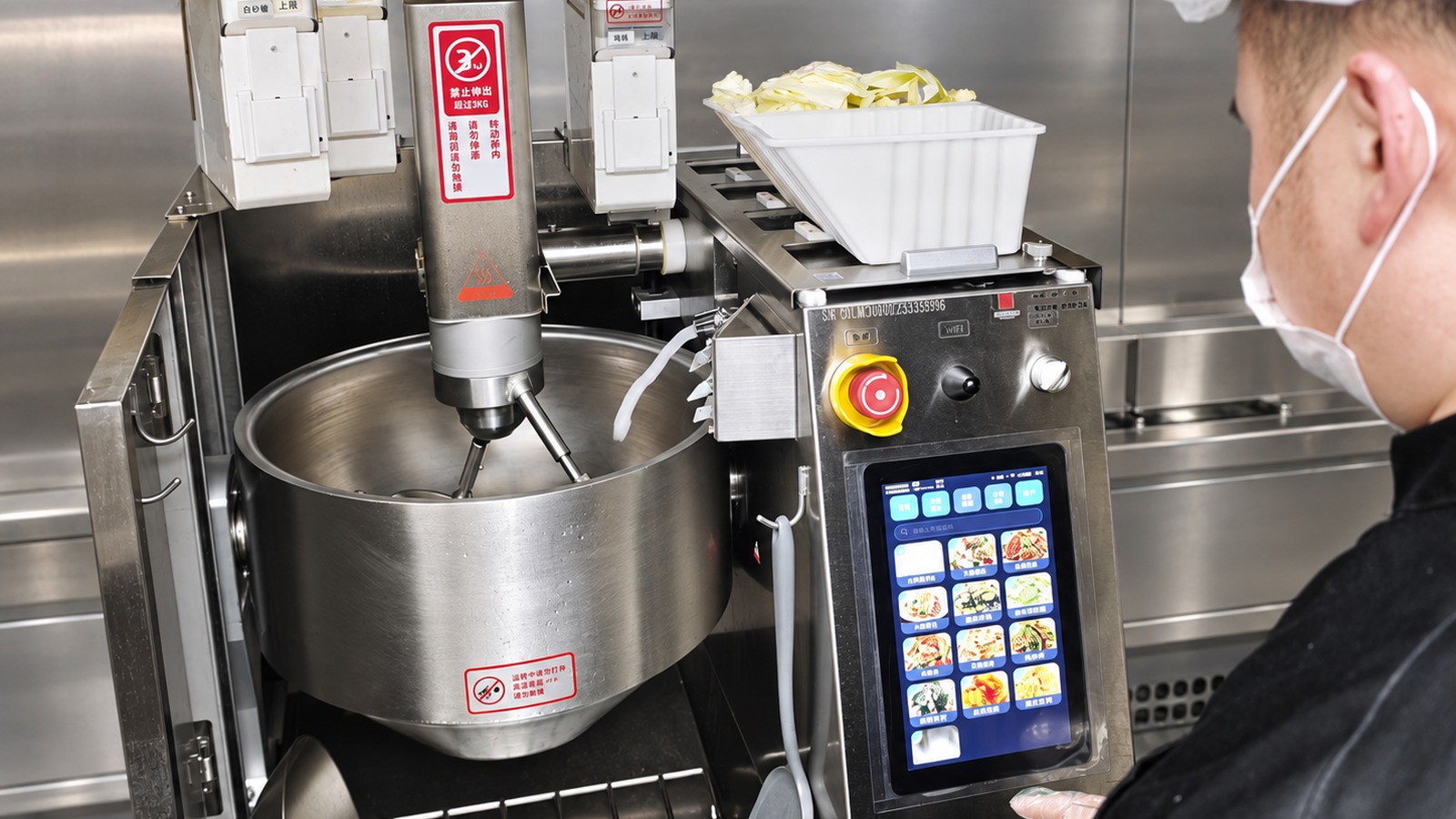 Cooking robot mixing assembly, ingredient tray and control panel showing interfaces to specify before vendor selection.