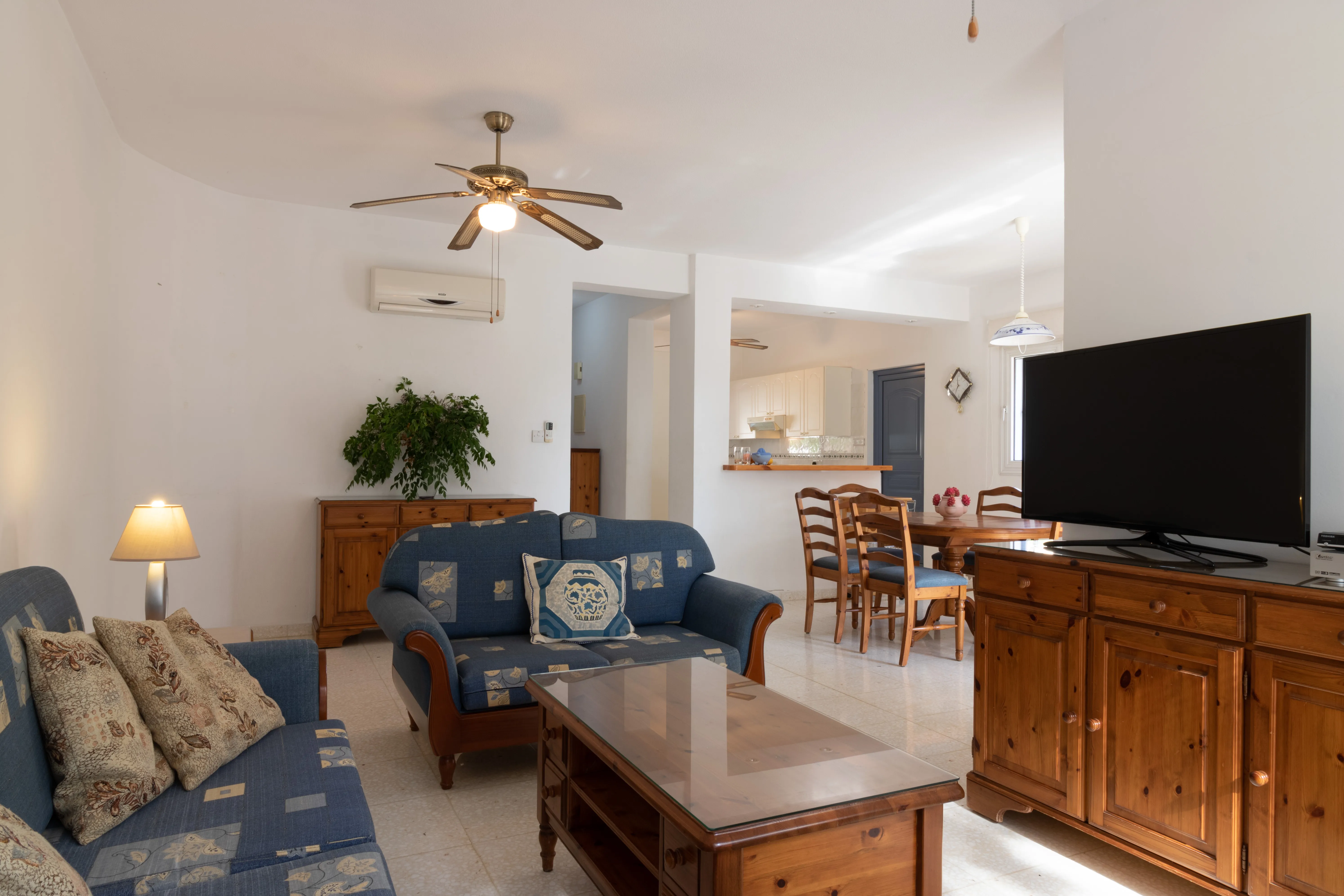 Open-plan living and dining area with kitchen hatch at Villa Nadezda