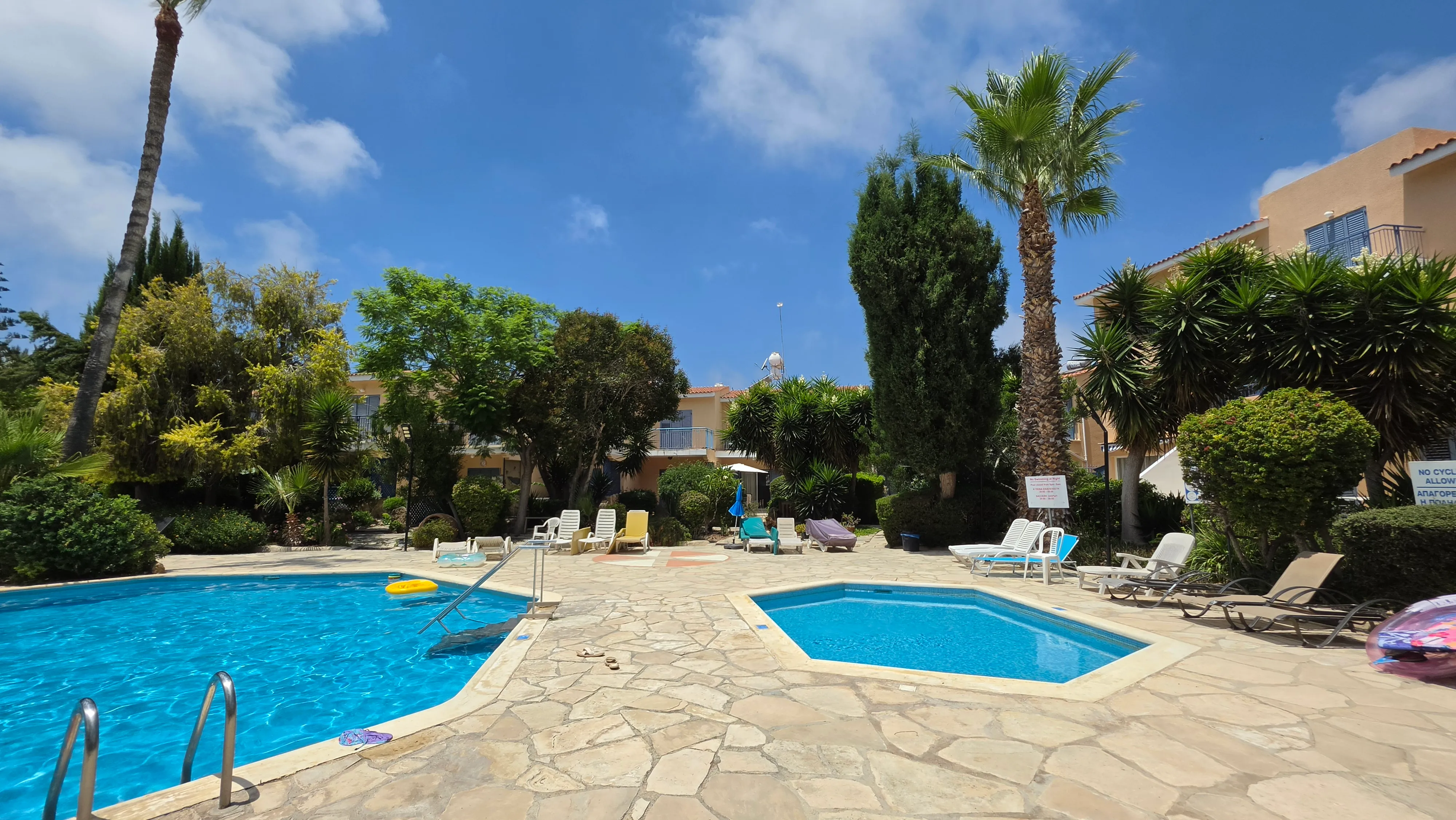 Adult and children's pools with palm trees at Paradise Gardens, Kato Paphos