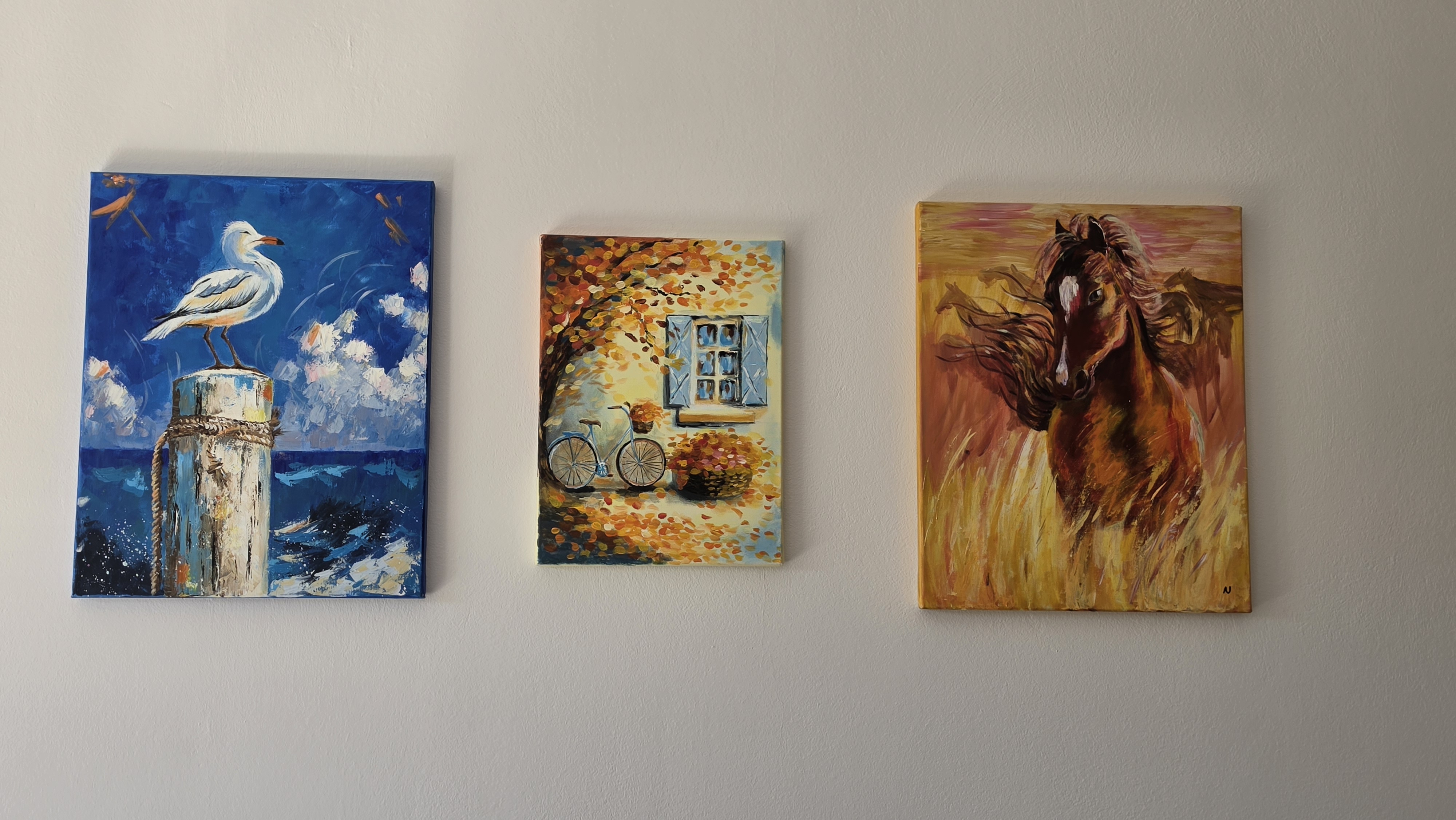 Three handmade paintings on the living-room wall at Villa Nadezda, Paphos